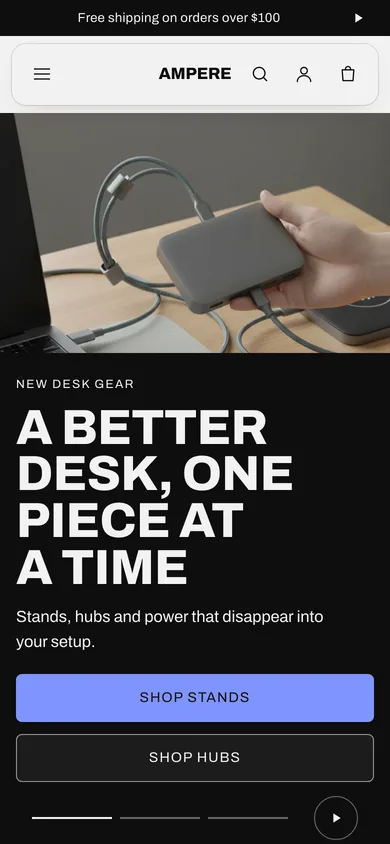 Ampere preset of the Tessera theme on a phone: a photograph of a hand holding a hub with braided cables under the heading A better desk, one piece at a time.
